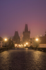 Landscapes on Charles Bridge with Bridge Tower and Statues at sunrise in a foggy morning, Prague, Czech Republic, Europe