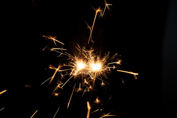 Firework sparkler burning isolated black background, shining fire flame, celebration festival happy holiday new year and merry christmas concept.