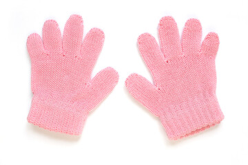 A pair of pink woolen gloves on a white background. Two children's knitted gloves for hands. Children's winter garment isolated. A warm accessory for a small baby girl.