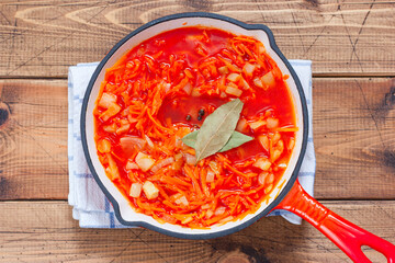 Step-by-step preparation of pollock in a marinade with onions and carrots, step 2 - preparation of tomato marinade with onions and carrots, selective focus, top view