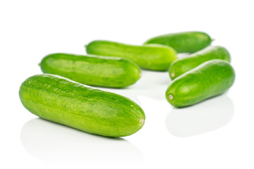 Group of six whole fresh green baby cucumber isolated on white background