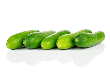 Group of five whole fresh green baby cucumber isolated on white background