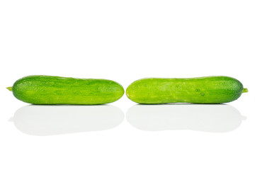 Group of two whole fresh green baby cucumber isolated on white background