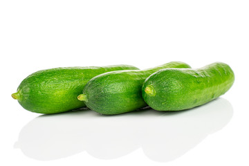 Group of three whole fresh green baby cucumber isolated on white background