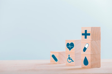 Emoticon icons healthcare medical symbol on wooden block , Healthcare and medical Insurance concept