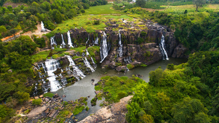 Aerial view for beautiful  Pongour waterfall in Vietnam. Amazing vietnamese nature with Buddha on the top of waterfall