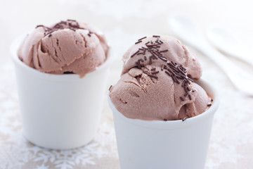 Homemade chocolate ice cream from sour cream and condensed milk in white cups, horizontal