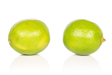 Group of two whole juicy sour green lime isolated on white background
