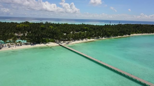 Aerial view to bungalow behing palms In Maldives Island in Indian ocean 4K