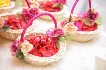 Basket with red flower petals.