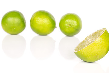 Group of three whole one half of sour green lime isolated on white background