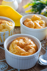 Egg casserole with cheese in a white portioned ramekin, selective focus