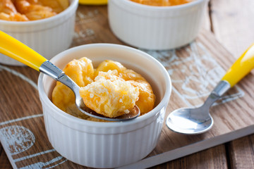 Egg casserole with cheese in a white portioned ramekin, selective focus