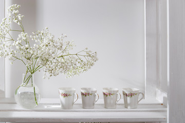 Wedding bouquet in glass vase on a shelf