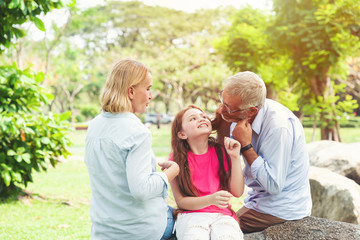 Senior family with daughter playing outdoor