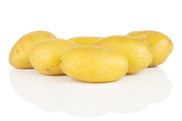 Group of six whole pale yellow potato isolated on white background