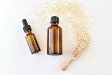 Organic sesame seed cosmetic oil in brown amber bottles, mock up.