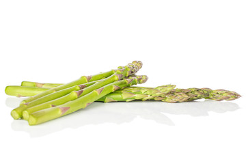 Group of seven whole healthy green asparagus isolated on white background