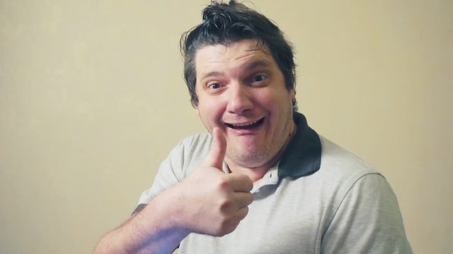 portrait of funny surprised middle aged emotional man with smartphone