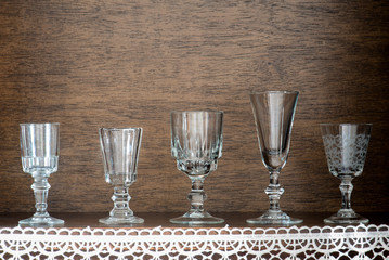 Row of old vodka glasses on shelf