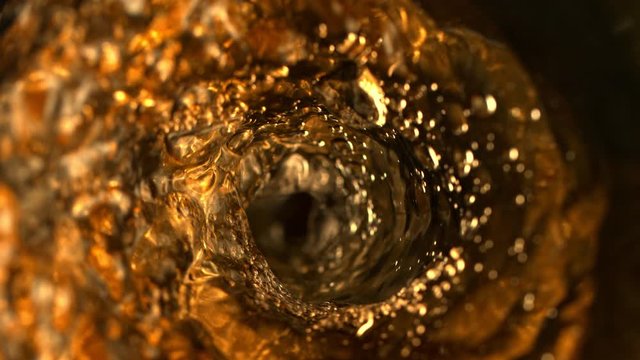 Super Slow Motion Abstract Shot of Pouring Golden Liquid in Glass Bottle at 1000 fps. Filmed with High Speed Cinema Camera in 4K Resolution.