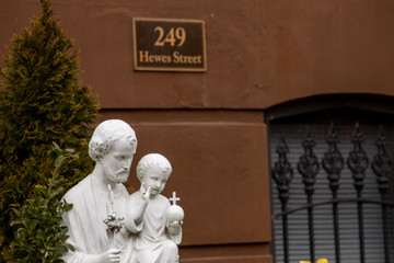 A St Joseph with Jesus child statue in a Jewish neighborhood at Brooklyn, New York