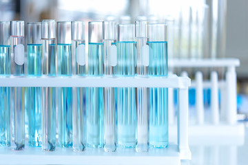 Close up Pipette dropping a sample into a test tube for research tool anatomy of small organisms with metal lens at laboratory, Biology science and medical concept.