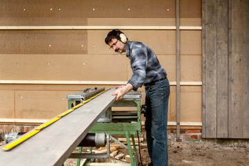 Man at the Circular Saw, Insulating and Paneling an Outside Wall