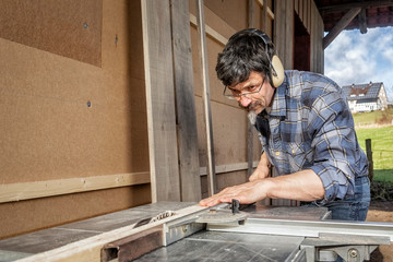 Man at the Circular Saw, Insulating and Paneling an Outside Wall