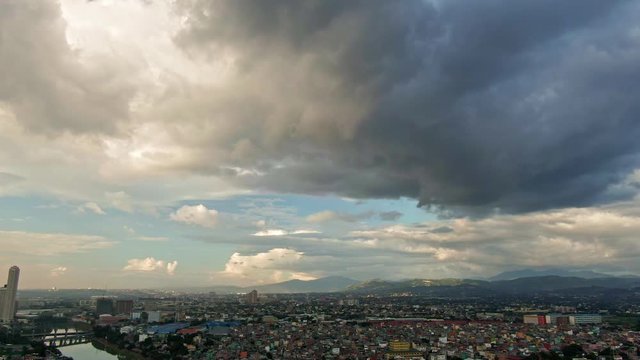 Wde view of cityscape almost covered of massive dark grey cloudy clouds before its rain
