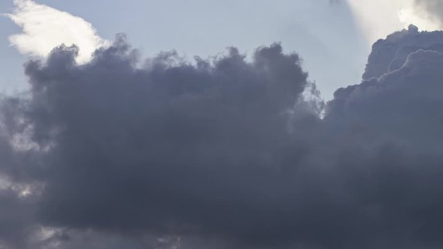 Time lapse of massive cumulus clouds rolling massive  and fading in the sky