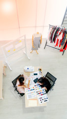 Two young designer planing in garment industry