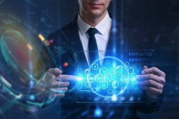 Business, Technology, Internet and network concept. Young businessman working on a virtual screen of the future and sees the inscription: Employee benefits