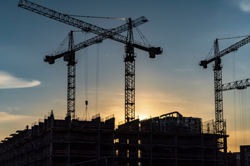 Cranes working day and night on construction of the housing estate in former industrial zone