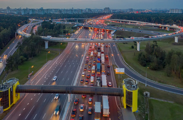 View from the air on the movement of cars on the overpasses at the intersection with the ring road and the exit from the city