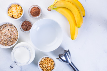 Ingredients for Banana Smoothie on a white background. Healthy eating concept.