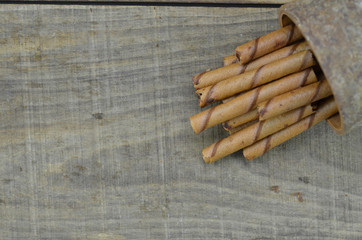 Delicious chocolate wafer roll stick on wooden background