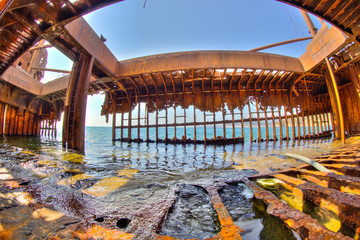 Interior of rusty shipwreck in Greece full of sea water in Glyfada beach near Gytheio, Gythio Laconia, Peloponnese, Greece. Wide angle view.