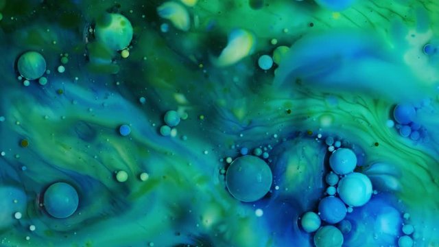 Fantastic structure of colorful bubbles in liquid ink. Fluid art. Liquid color paint explosion. Macro shooting 4K UHD footage