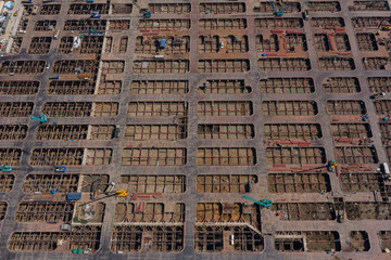 Fototapeta na wymiar Aerial view of a steel structure construction site Building ultra-tall buildings That requires the expertise and expertise of a team of technicians and engineers to make the building that is built is 
