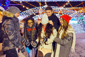 Cheerful people on Christmas fair in winter