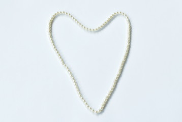 pearl necklace arranging hearth shape on white background