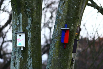 Birdhouses in many colours in park