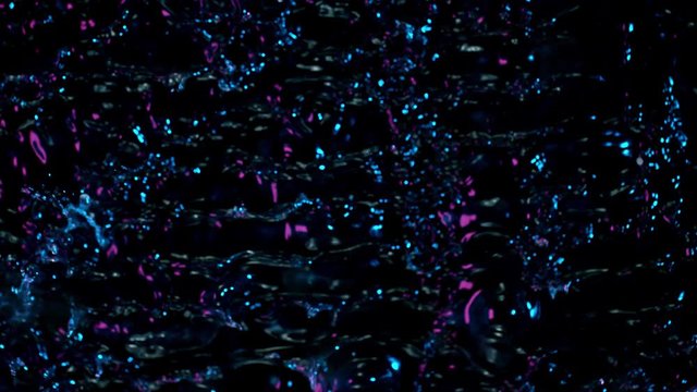 Super Slow Motion Abstract Shot of Splashing Neon Water at 1000fps. Filmed with High Speed Cinema Camera in 4K Resolution