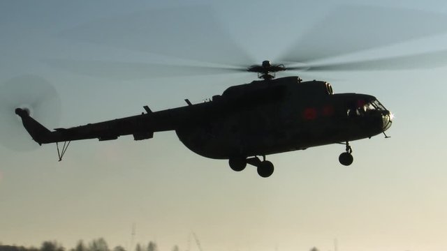 The helicopter lands at sunset