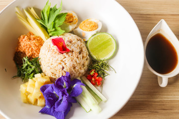 Thai Southern Spicy Rice Salad with Vegetables on white plate, Thai local food.