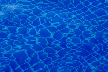 Blue swimming pool water ripple background.