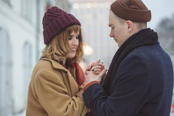 Romantic stylish couple embracing in cold winter streets. Dating, peeple and seasonal concept.