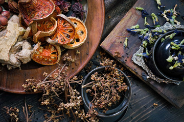 Spice and herbs. Dried herbs flat lay with selective focus on bael fruits. Rustic concept.