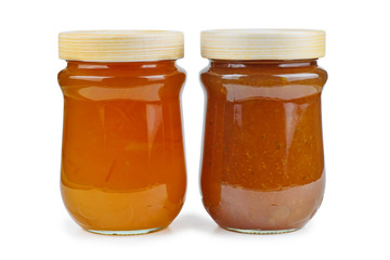 Homemade jam in glass jars isolated on white background